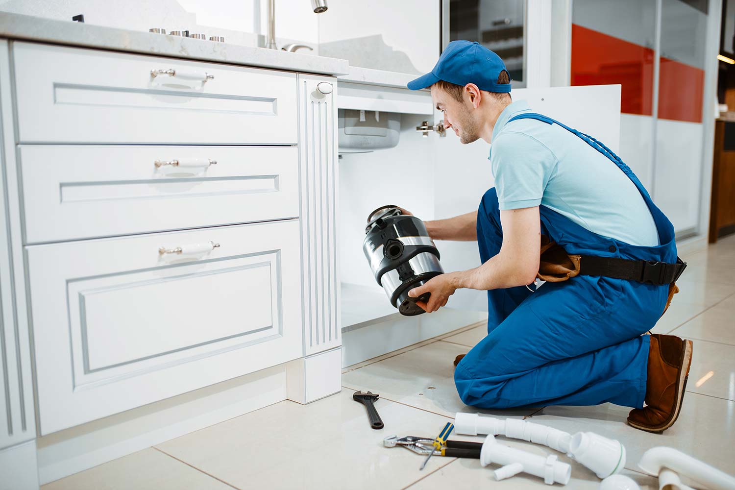 male-plumber-in-uniform-installing-disposer-resize.jpg